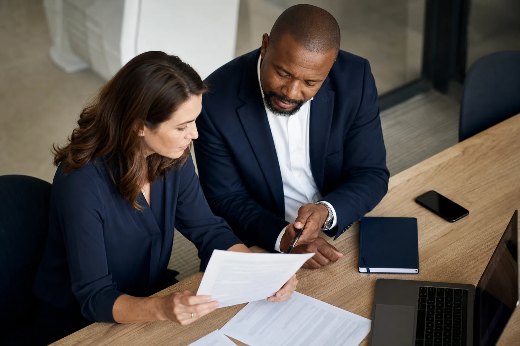 A professional reviewing a document pack and making notes before choosing a signing method